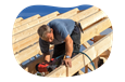 A carpenter building a roof for a client project